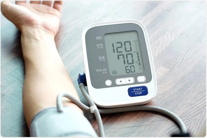 blood pressure machine hooked up to an arm showing the numbers 120 over 70
